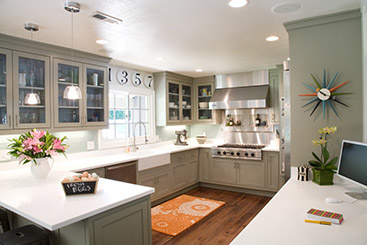 A large kitchen with sage green shaker cabinets. 