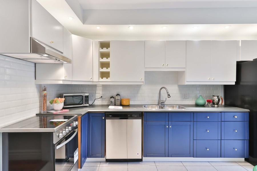 A modern kitchen with two-tone thermofoil cabinets. 