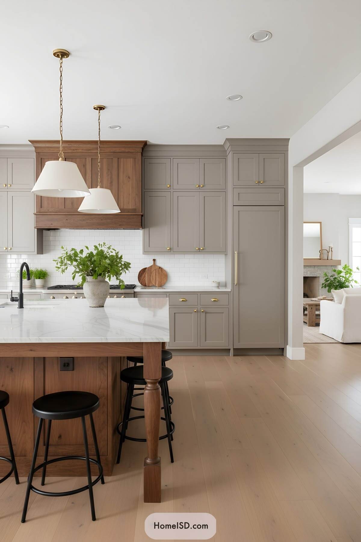 greige shaker kitchen cabinets with wood range hood and white backsplash