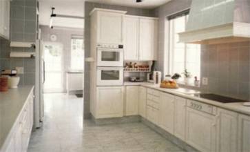 A galley kitchen with white cabinets.