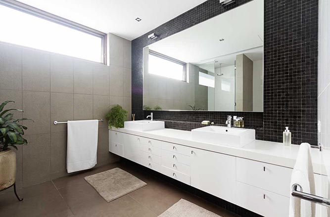 A modern double bathroom vanity with white thermofoil cabinets