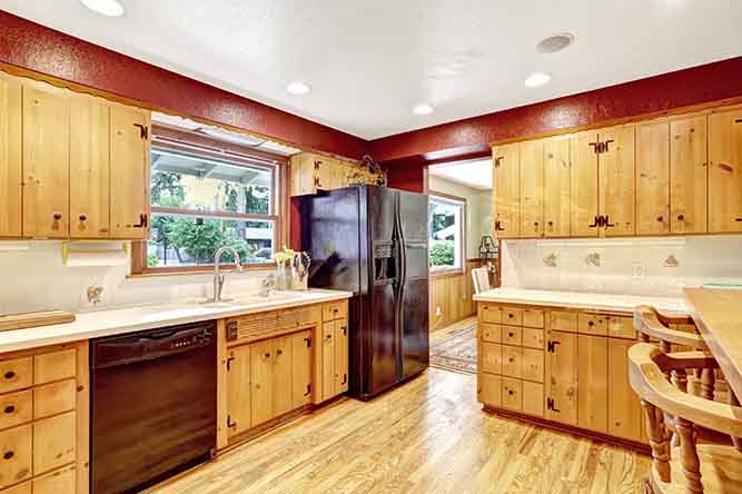 A large kitchen with natural finished, slab-style cabinets.