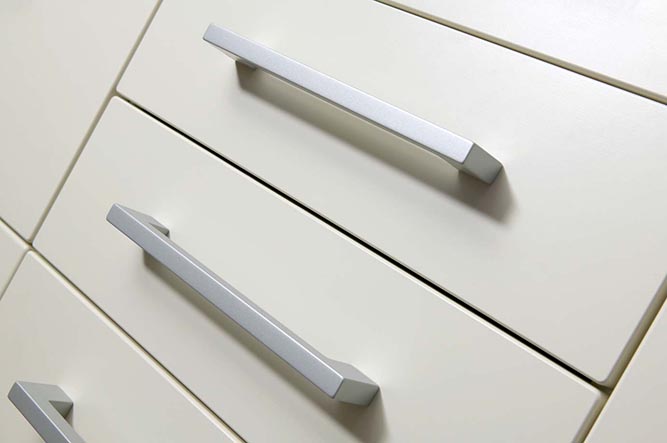 A row of drawer fronts with metal cabinet pulls.