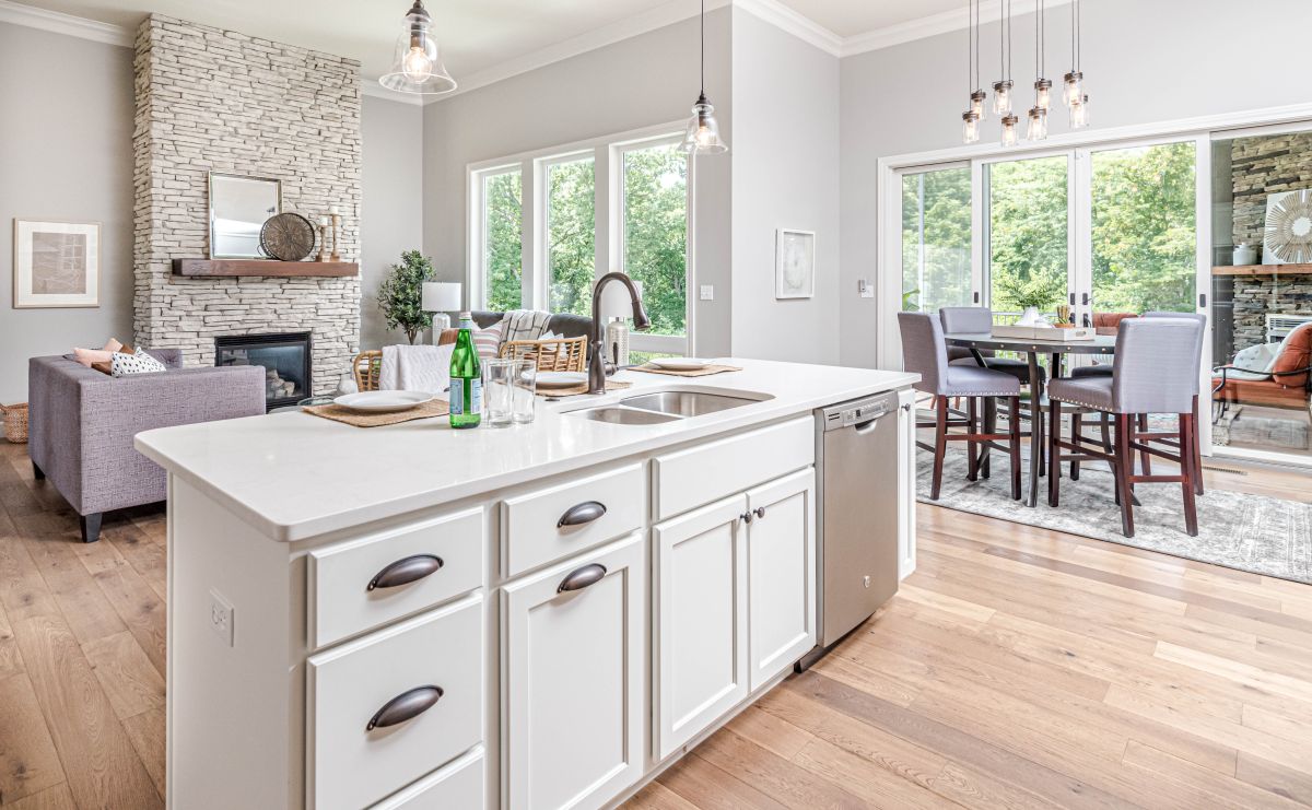 A kitchen island with white cabinet doors and drawers.