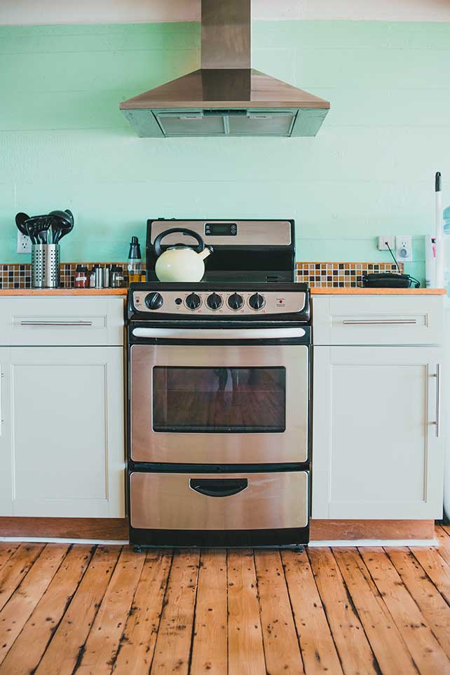 A kitchen with white shaker cabinets