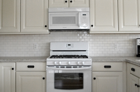White cabinets from CabinetNow and appliances featured by Ana White.