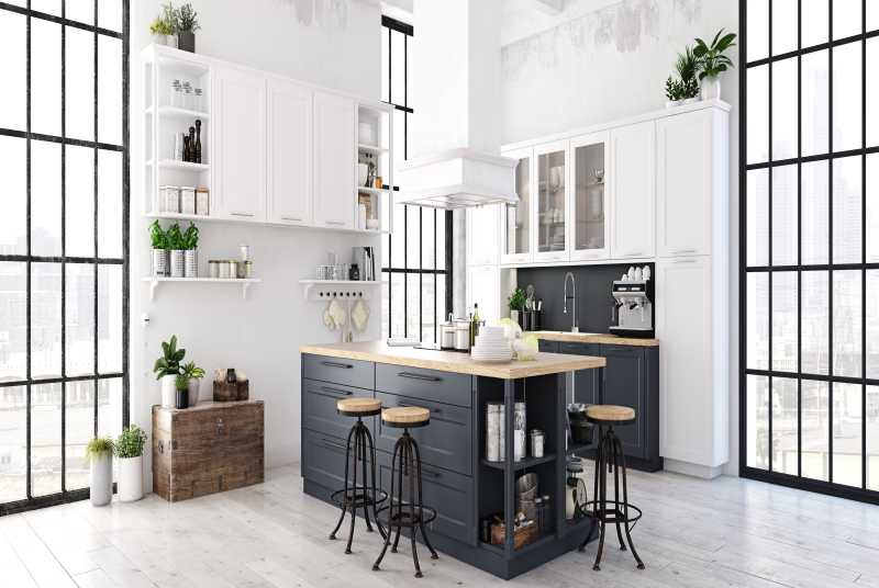 A large kitchen with black and white cabinets and wood accents.