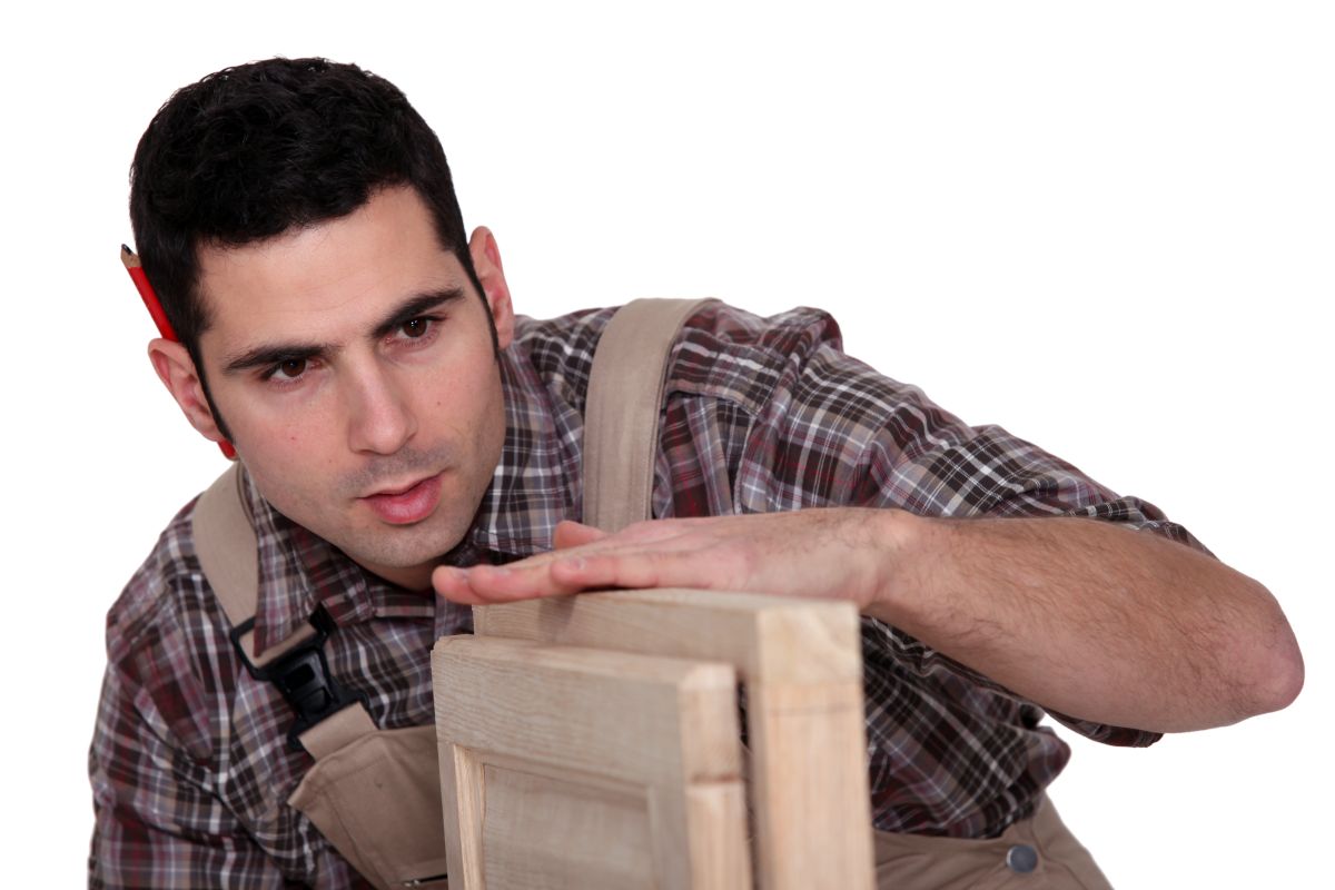 A person inspecting a cabinet.