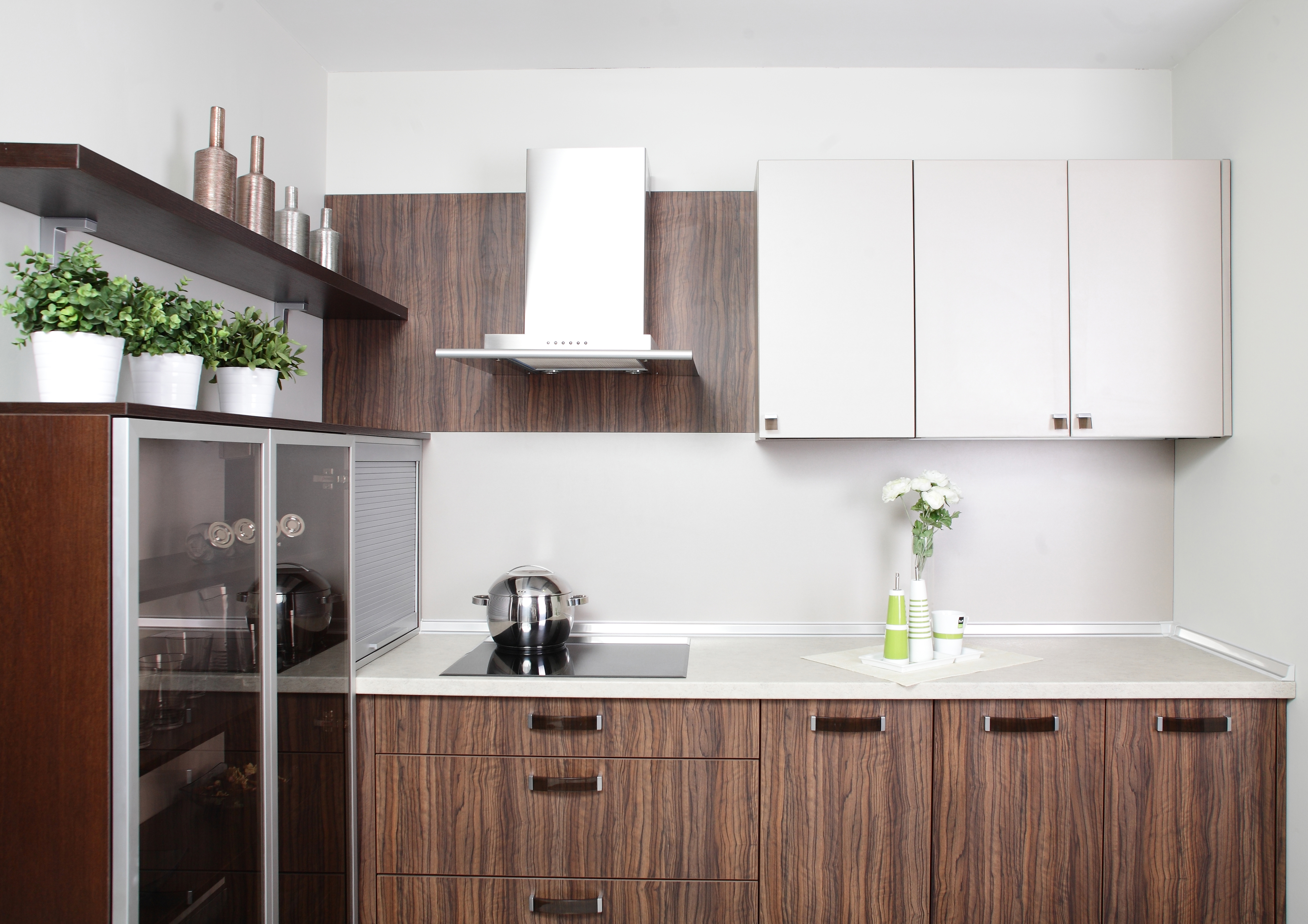 a white and wood tone cabinet area with a glass front refrigerator.