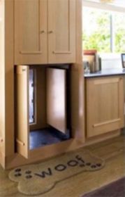 A doggy door hidden inside a cabinet.