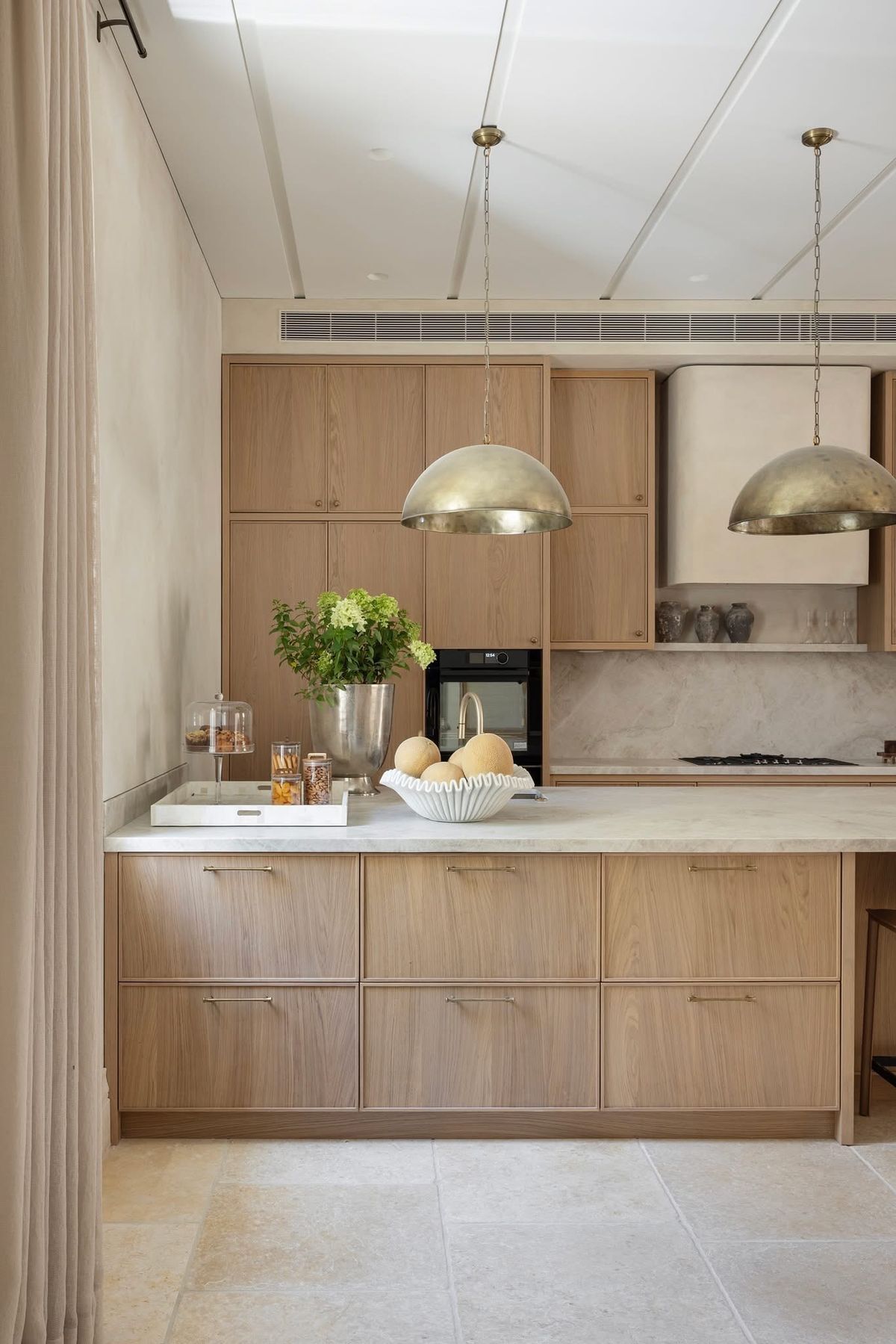 Natural white oak slim shaker cabinets with light wood grain, minimal hardware, and modern European kitchen design.