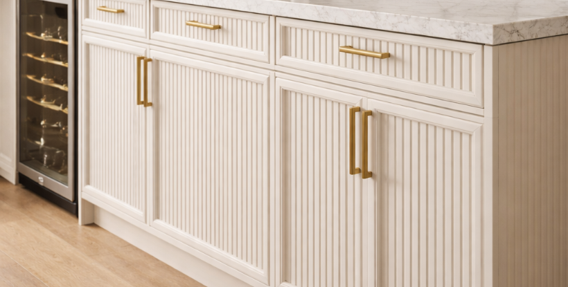 White fluted cabinets with gold hardware