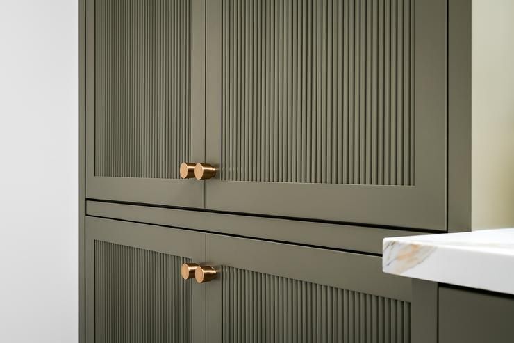 gray green fluted cabinet doors in modern kitchen design