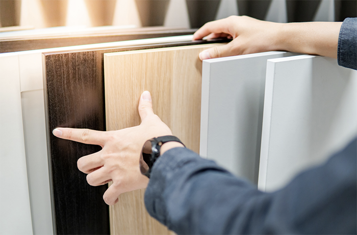 A person choosing cabinet door materials.