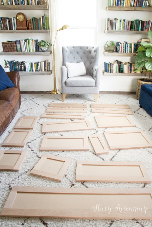 Unfinished cabinet doors and drawer fronts laid out on the floor.