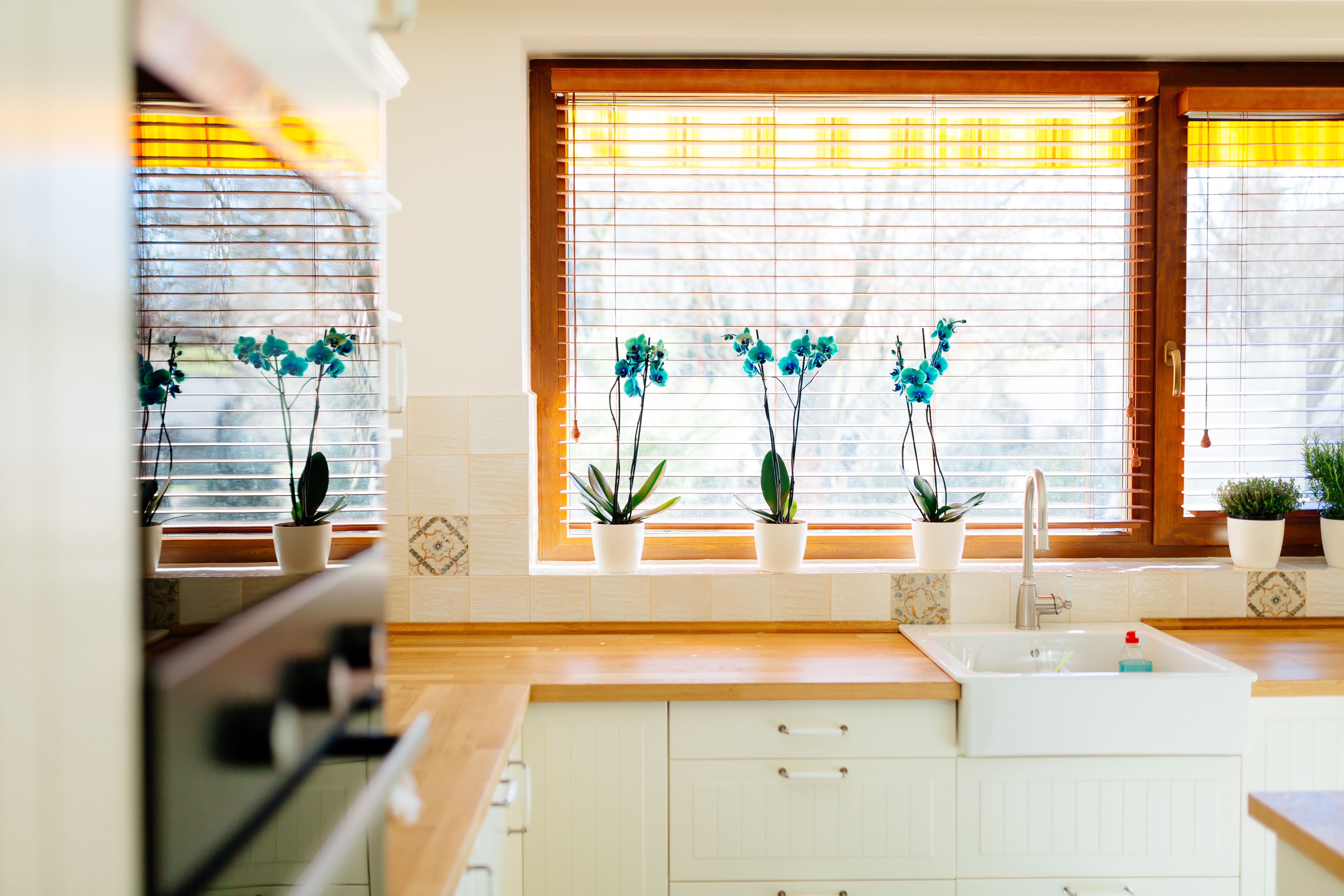 A bright kitchen with white cabinets