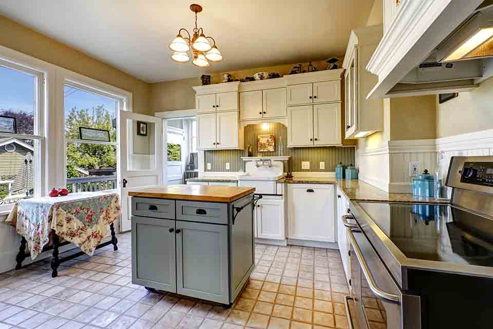 A kitchen with bright white shaker cabinets.