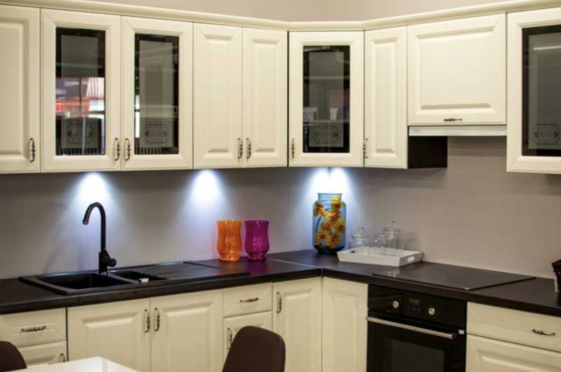 A kitchen with bright white cabinets. 