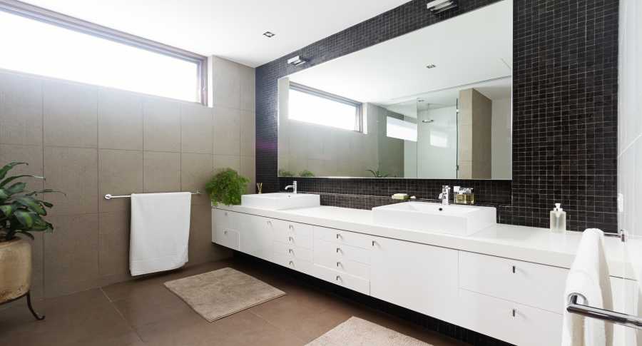 A large, modern bathroom with a double vanity.