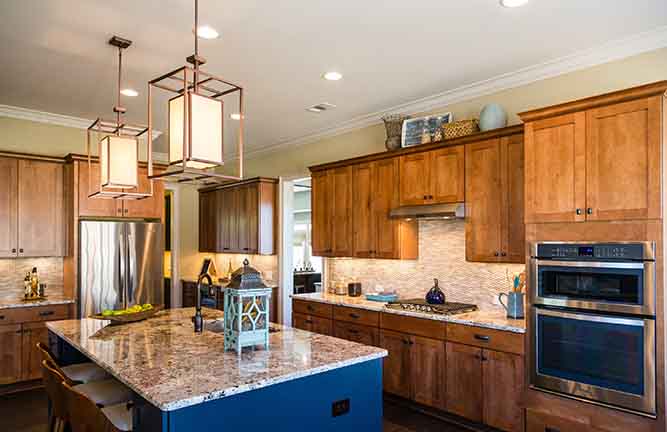 A kitchen with natural finish shaker cabinets. 