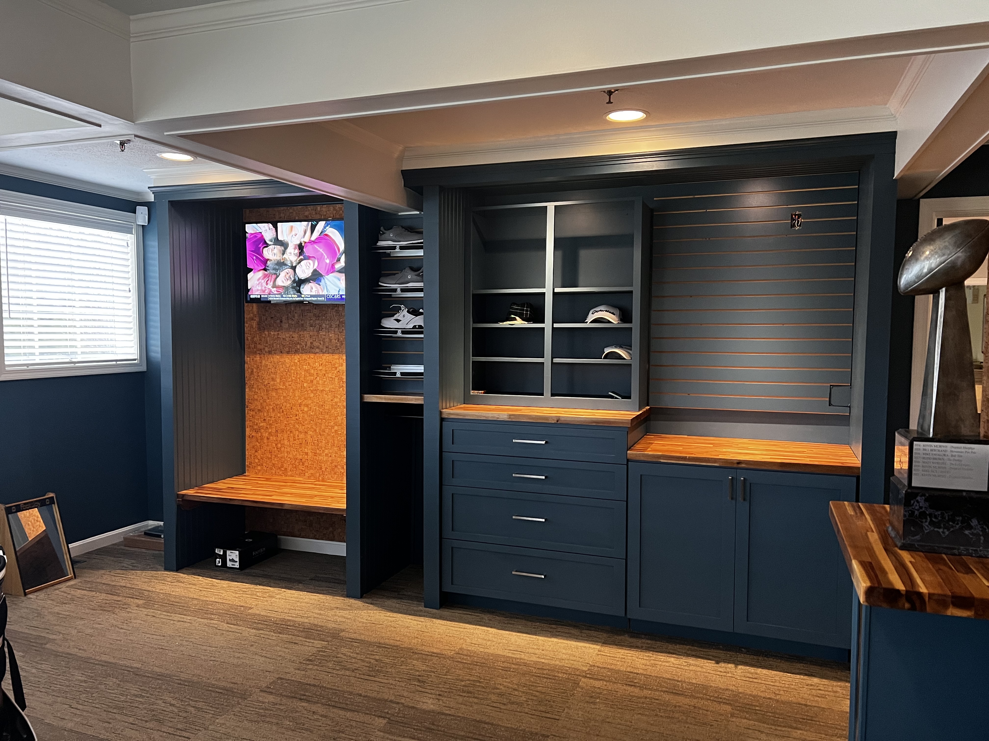 Customer navy blue custom closet built-ins with cabinetry, drawers, open shelving, and hanging storage