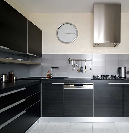 Slab style black kitchen cabinets in a bright kitchen