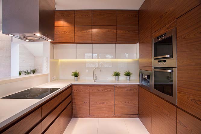 A modern, U-shaped kitchen with thermofoil cabinets