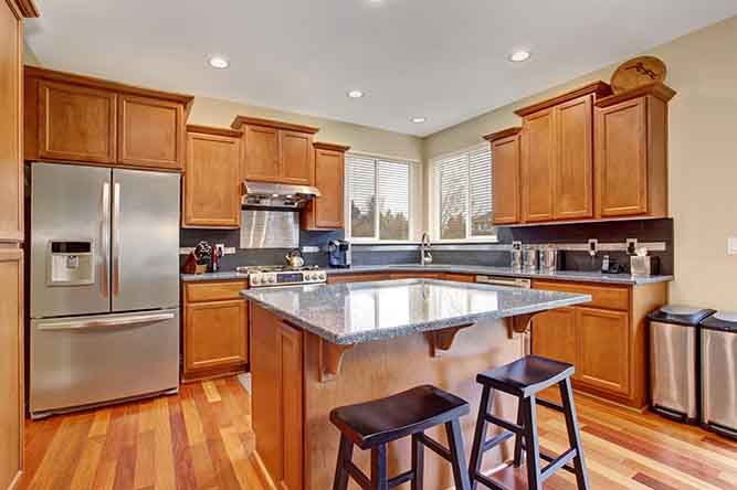 A traditional kitchen with natural finish cabinet doors.