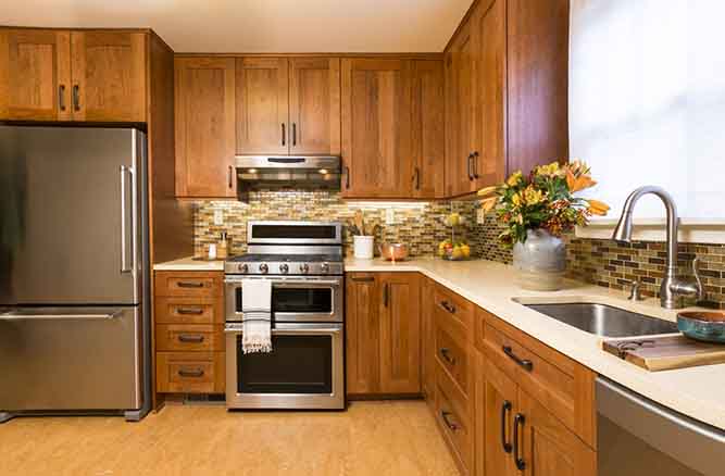 A kitchen with shaker cabinets stained a cherry color.