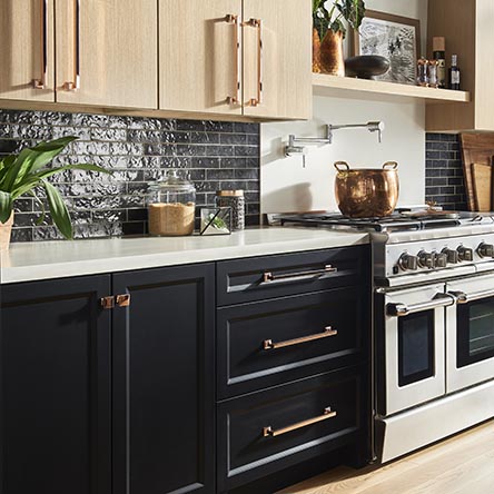 Two toned thermofoil kitchen with black and wood tone cabinets