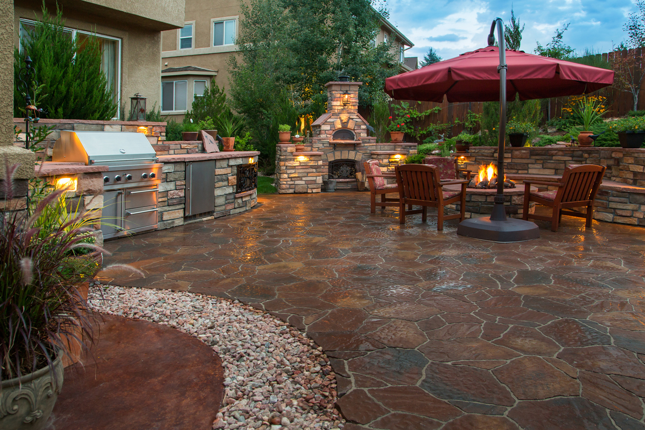An outdoor kitchen area with a grill. 
