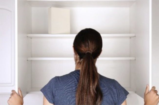 Person looking into an empty cabinet