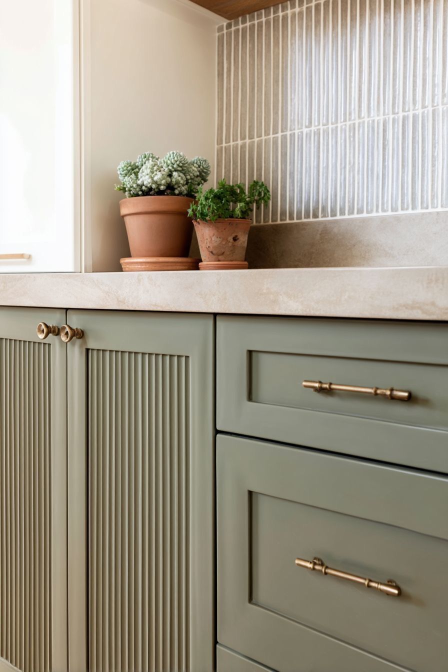 sage green fluted cabinet doors in modern kitchen