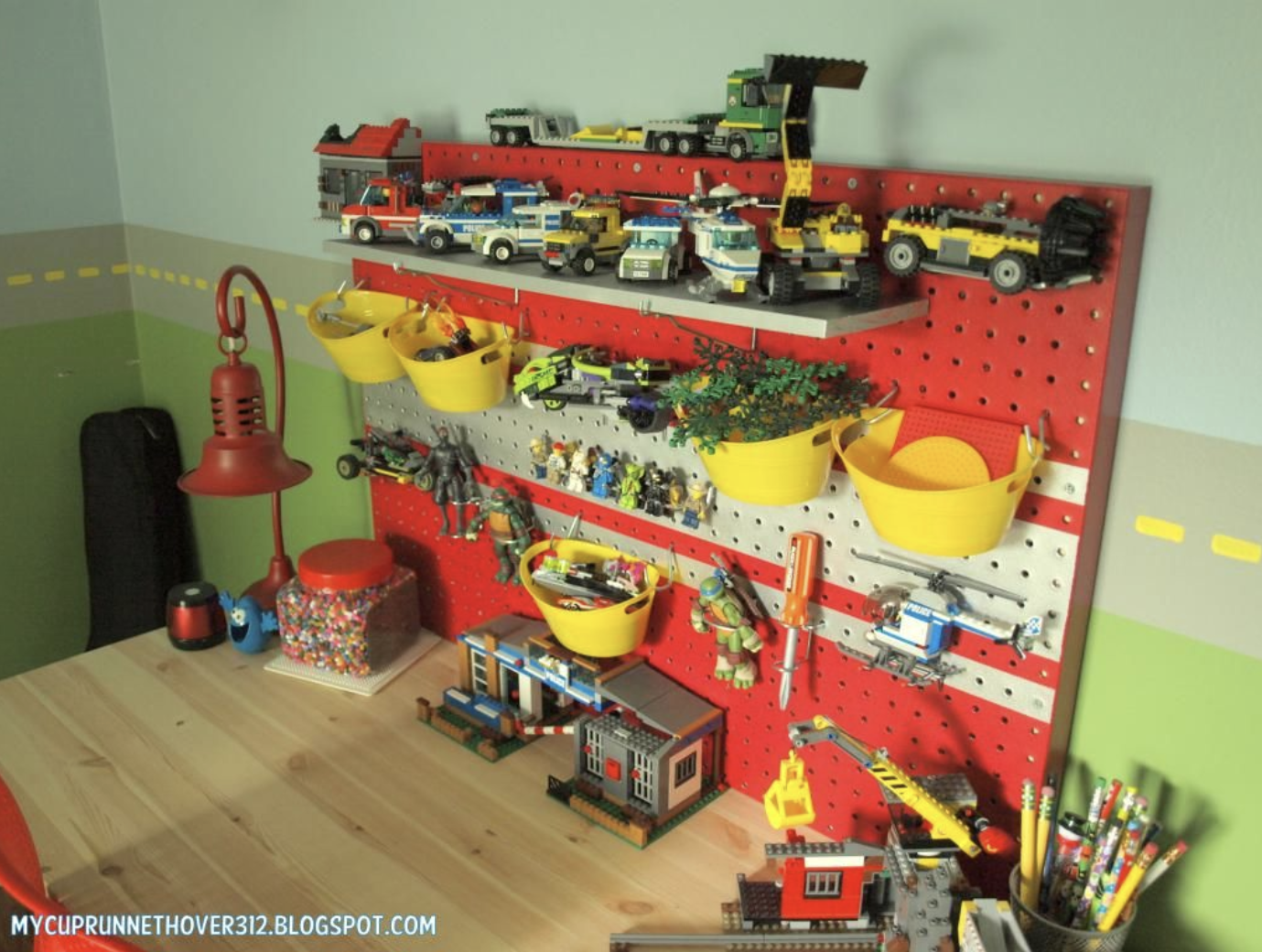 Toys kept organized on a pegboard.