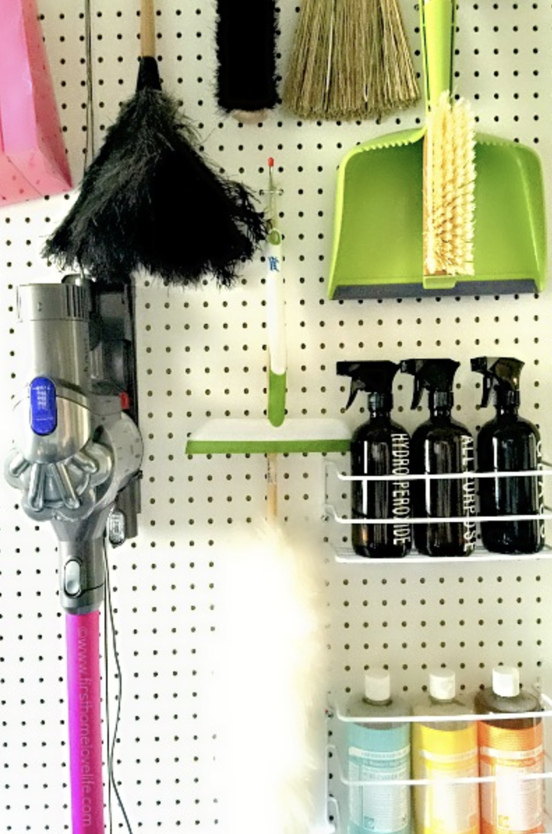 Cleaning supplies organized on a pegboard.