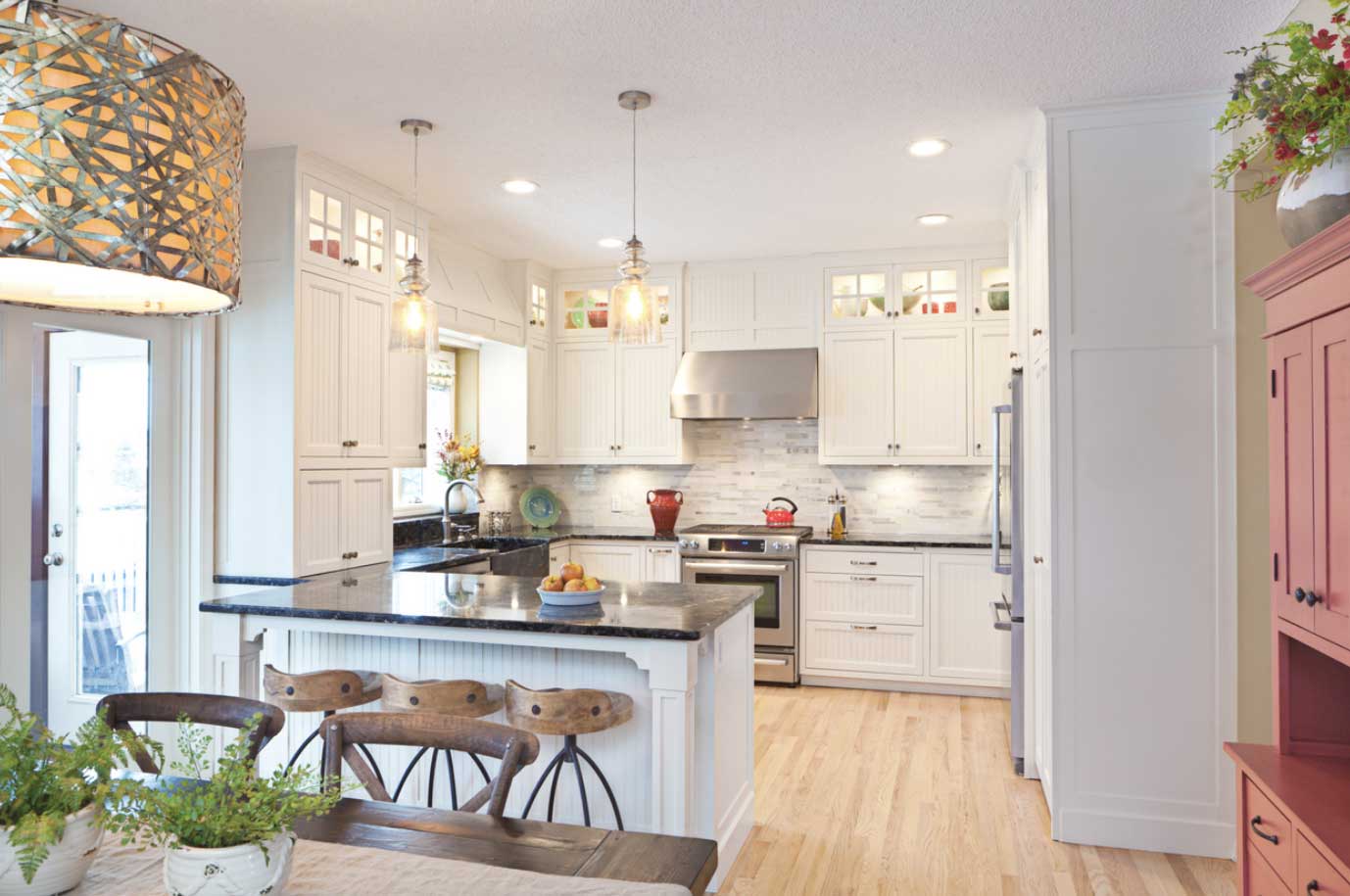 A kitchen with white, shaker cabinets.