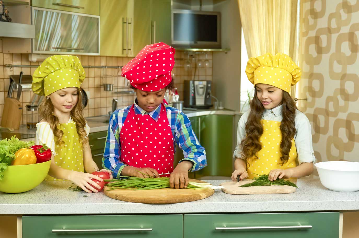 Children at a play kitchen with produce.