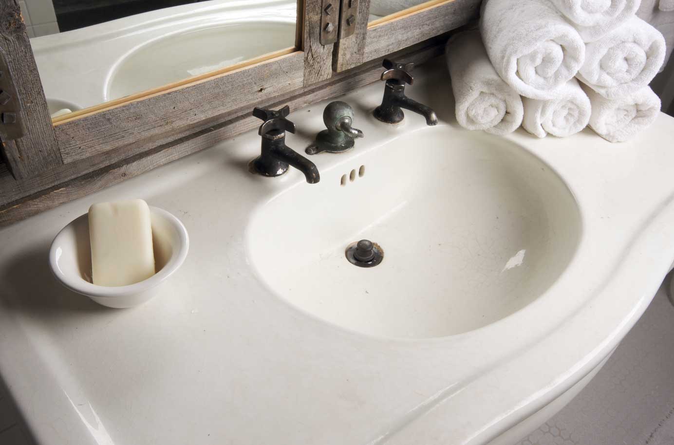 A white basin unit sink with silver fixtures.