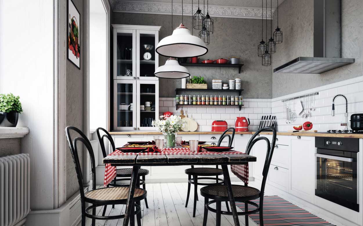 A kitchen, with grey walls, white cabinets and a 4 person table in the center with pendant lamps hanging over the table.