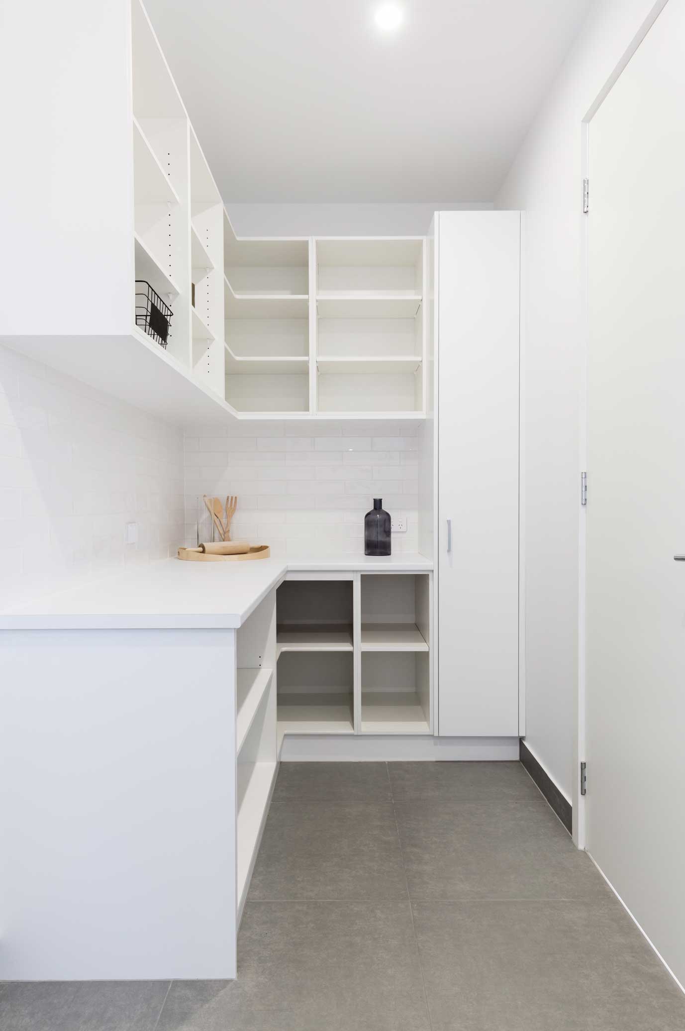 A white kitchen pantry with open cabinets.
