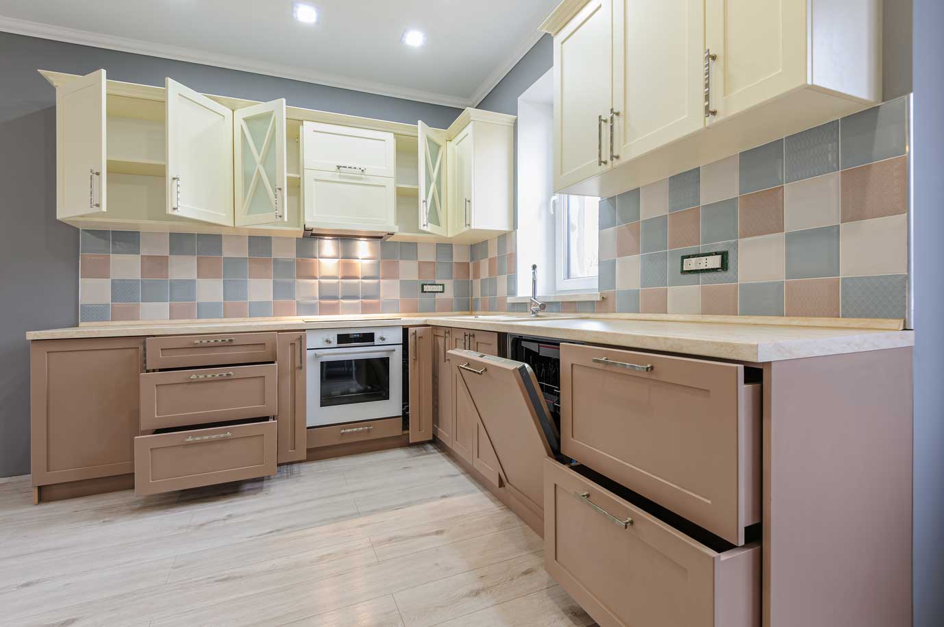 A unique farmhouse kitchen with a light green, mauve and blue color scheme, with frosted glass cabinets.