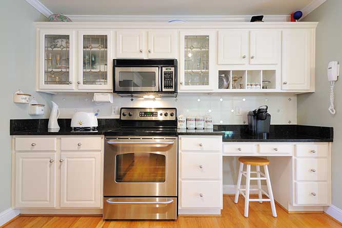 A single wall kitchen with partial overlay cabinets.