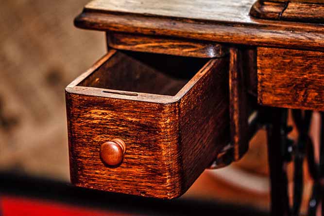 A small wooden drawer with a wooden knob