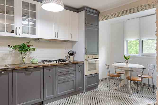 a two-tone kitchen with shaker style cabinets. 
