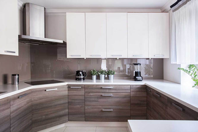 A two tone kitchen with slab-style thermofoil cabinets.
