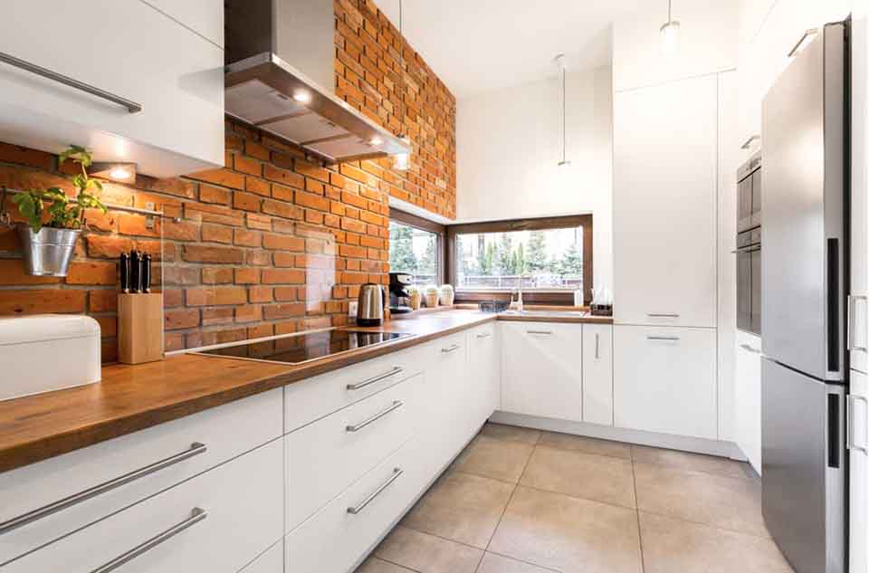 A U-shaped kitchen with slab-style kitchen cabinets.