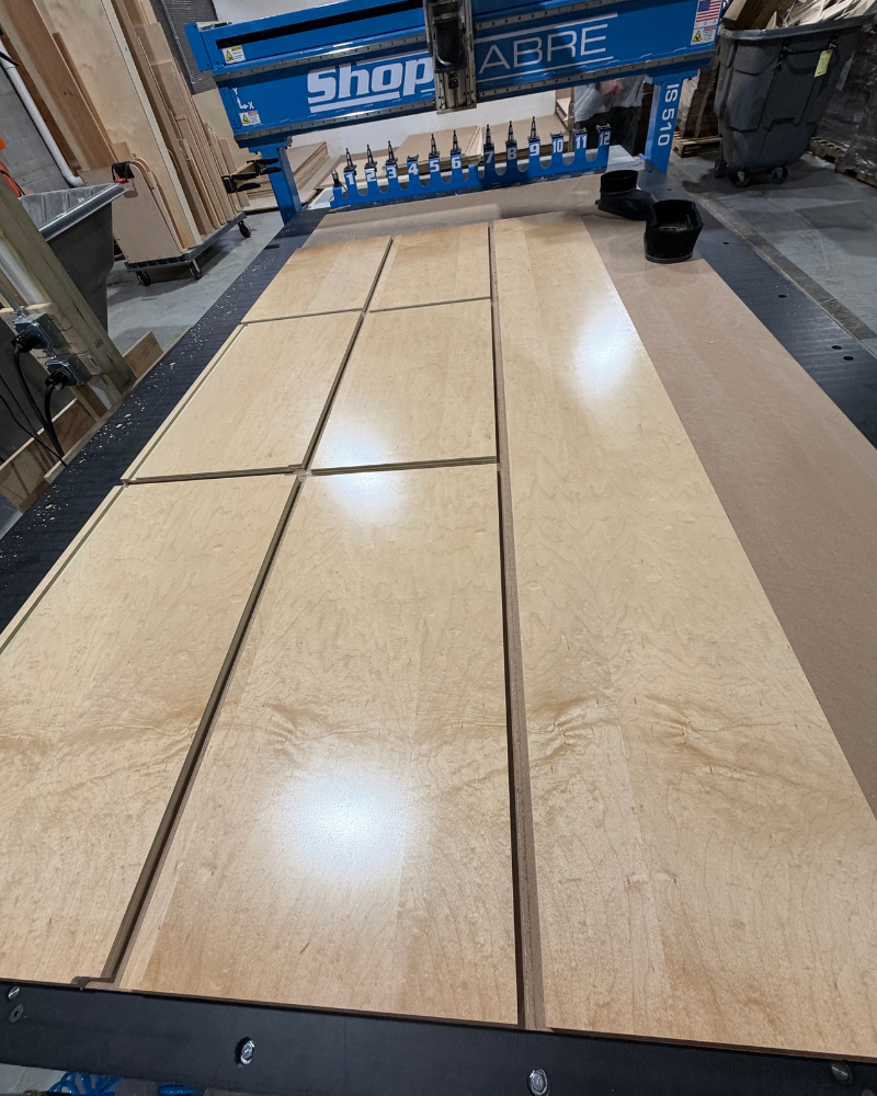 Nested UV finished maple cabinet box parts on CNC table