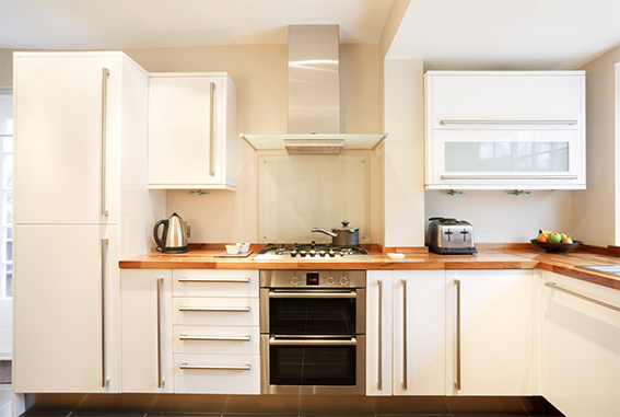 A small kitchen with white cabinets. 